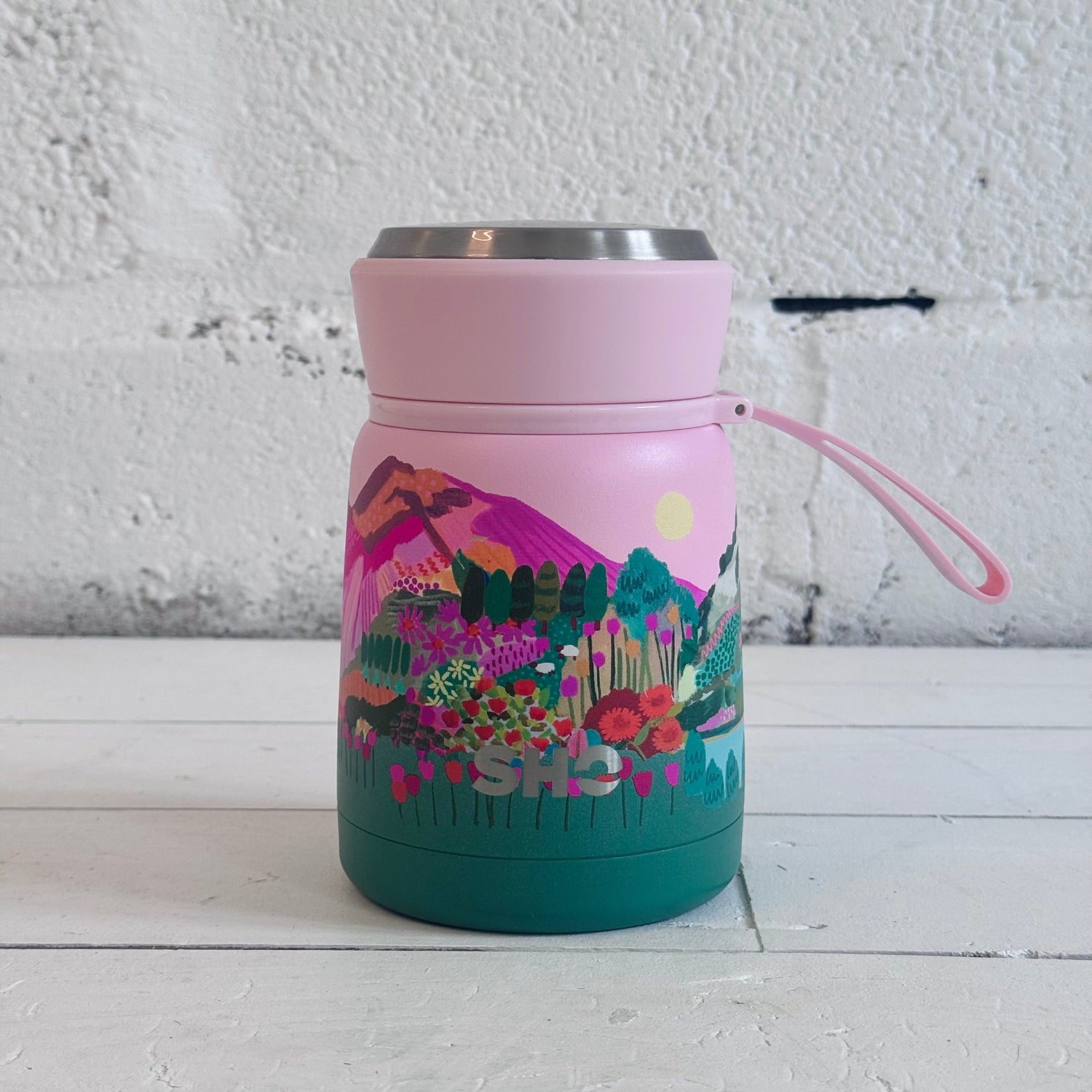 SHO reusable flask in mountain scene pink sky and green mountains 