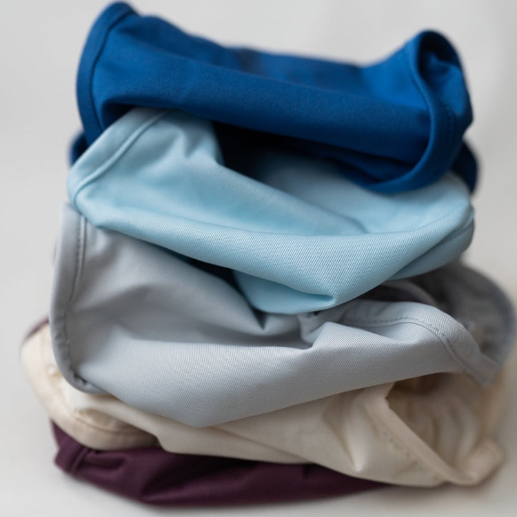 stack of little lamb wraps on top of one another - blue, light blue, silver, cream and purple