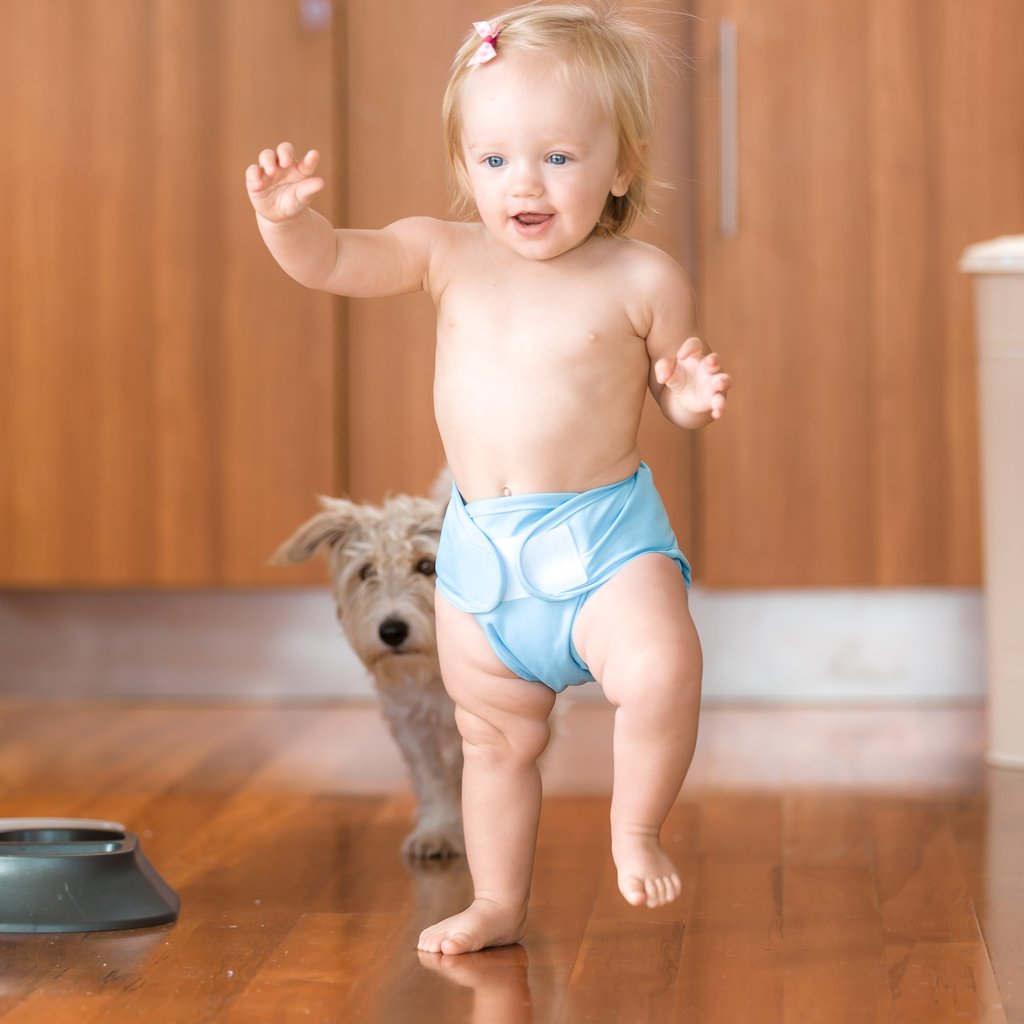 little lamb child wearing reusable cloth nappy and wrap